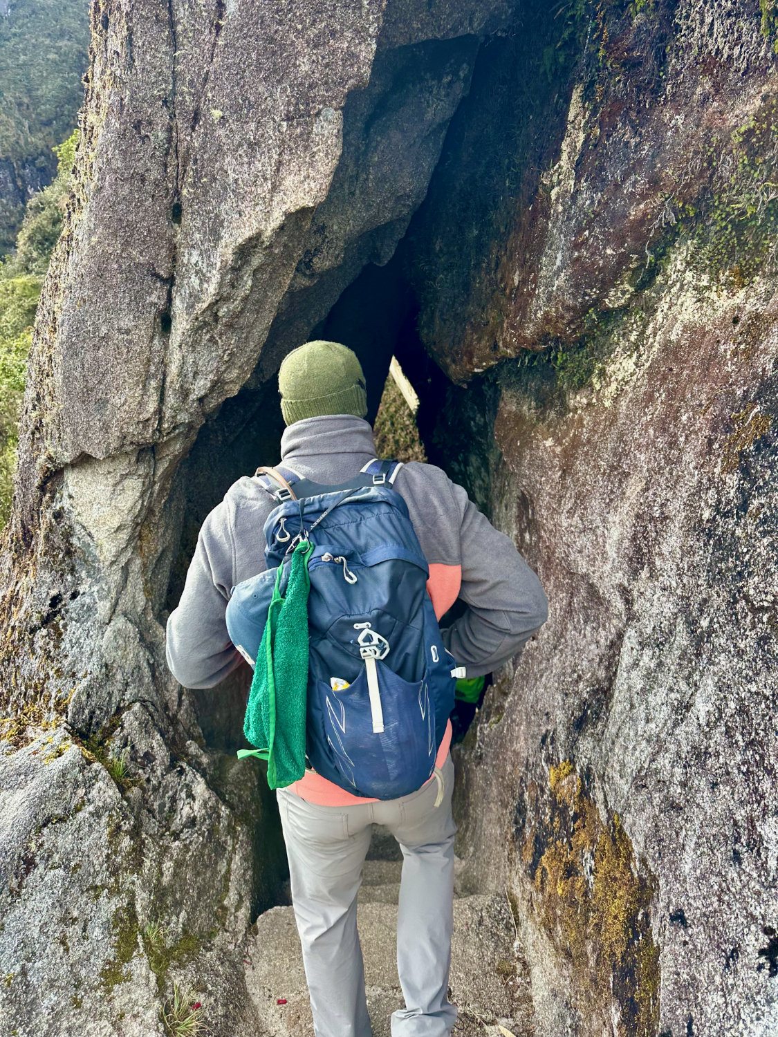 Inca Trail day 3. Coop (aka the Productive Adventurer) hiking through crack in rock