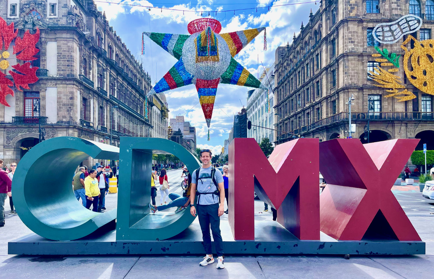 Standing in front of the CDMX sign in the Zócalo of Mexico City