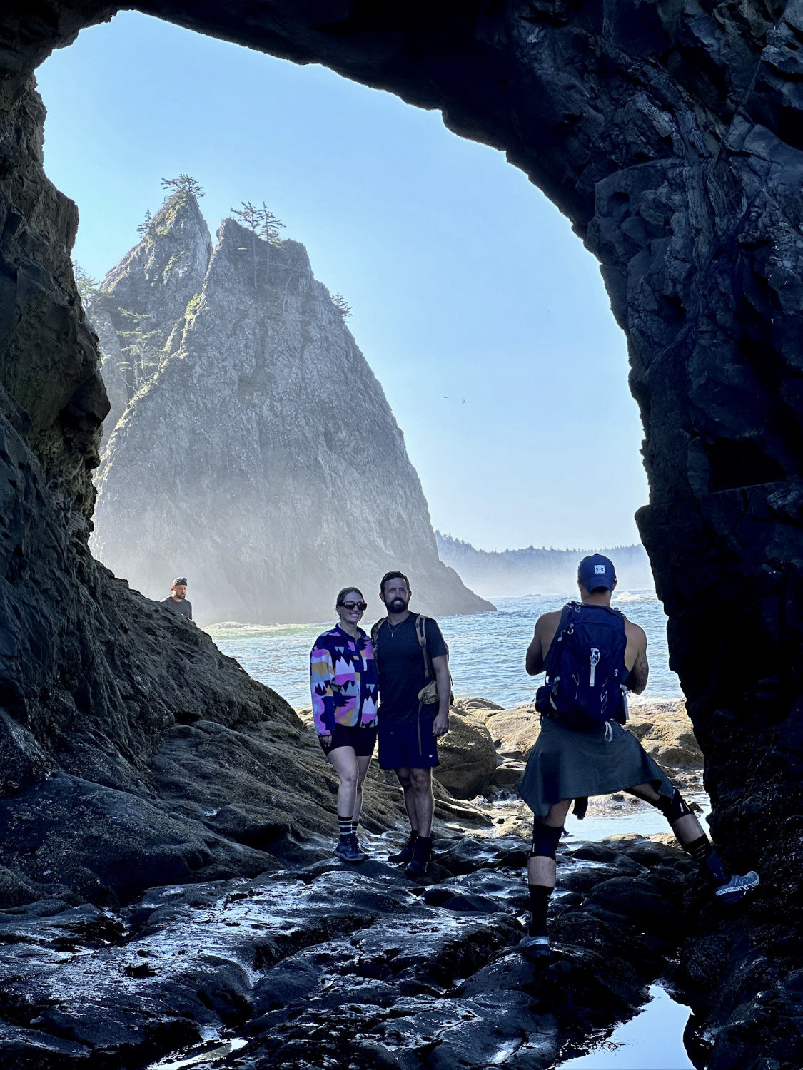 Coop (the Productive Adventurer) taking a picture of our friends Grant and Michelle at the 'Hole in the Wall' at Rialto Beach in Olympic National Park