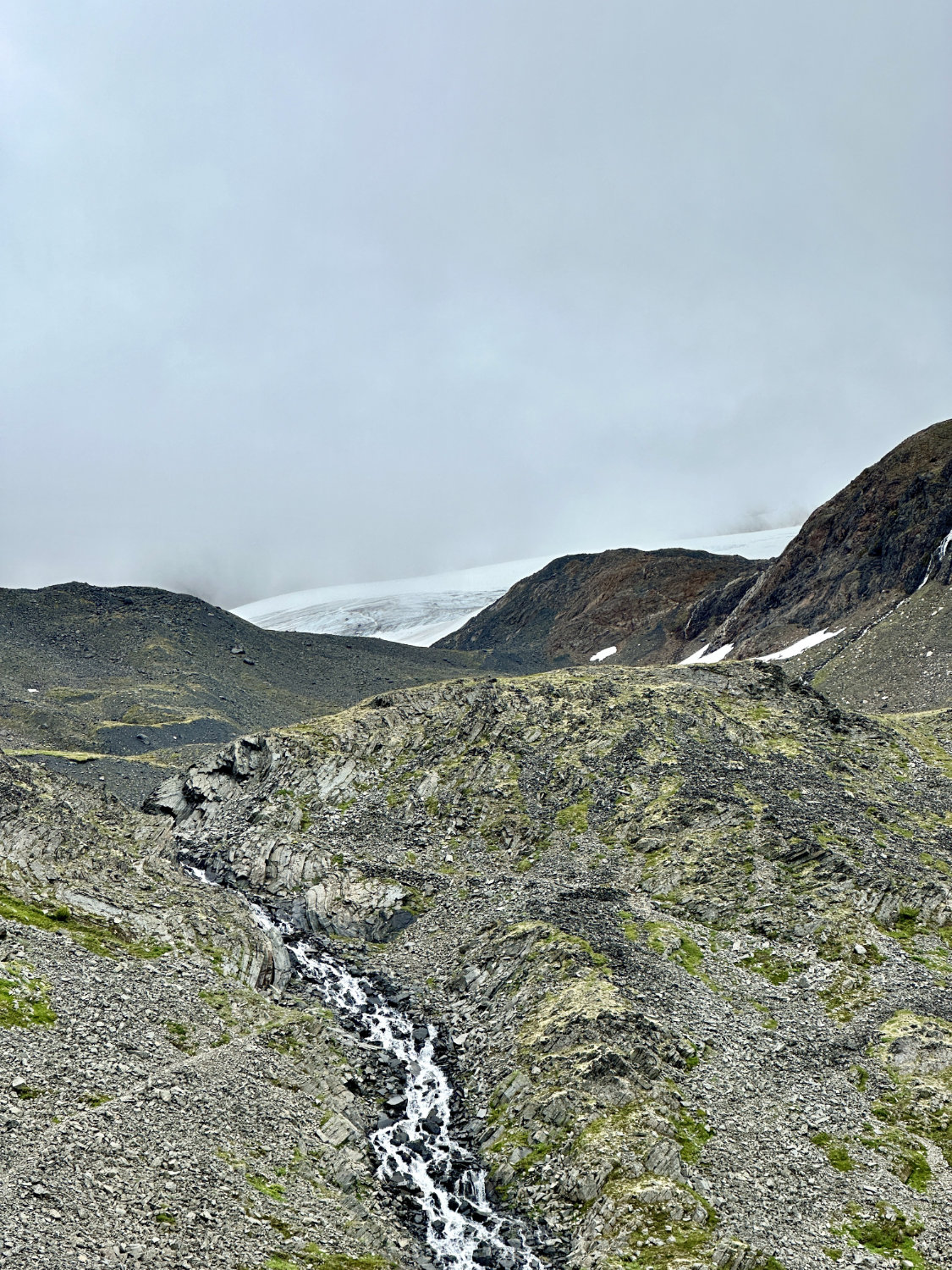 Cloudy view of Raven Glacier in the distance