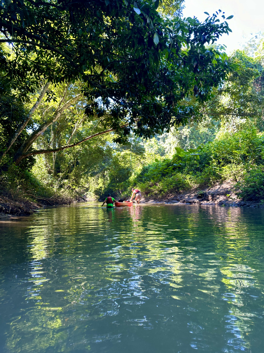 Coop and Mark beaching kayak in tributary