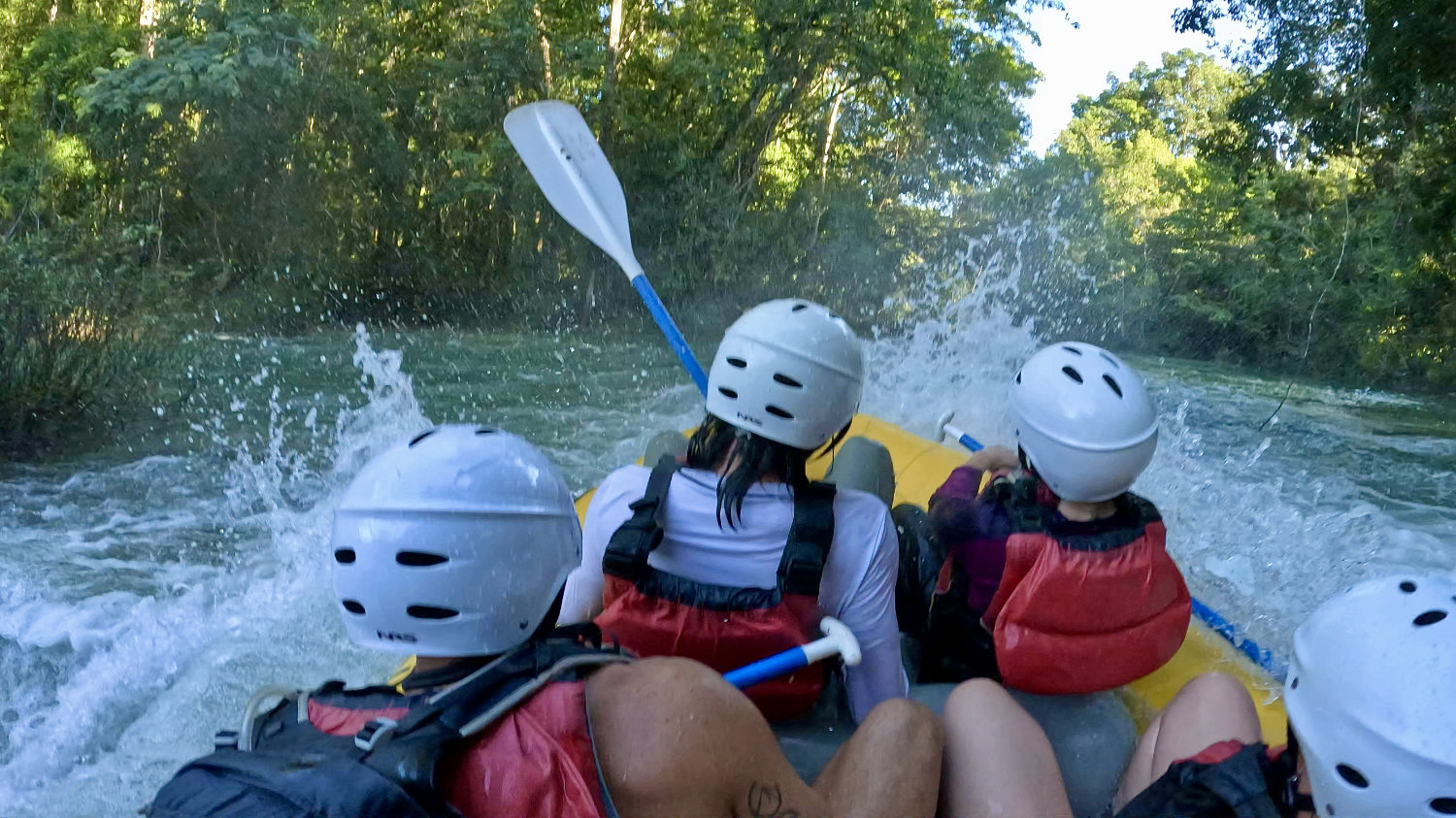 Water splashing in raft after going down a waterfall